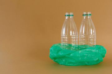 Plastic bottles in a plastic bag on a brown background