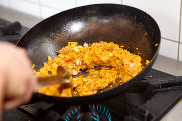 Cooked rice on a chinese wok on spicy sauce