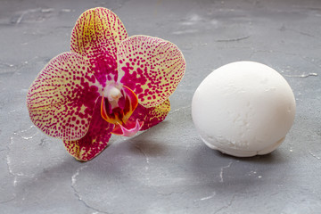 ice cream vanilla in a spoon and orchid flower