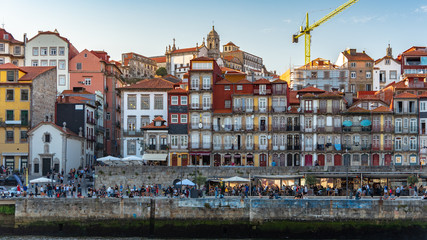 Portugal cityscape by the river with tourist (blurred face) hanging out - 346374250