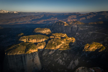 Mysterious hanging over rocks monasteries of Meteora, Greece at sunrise time