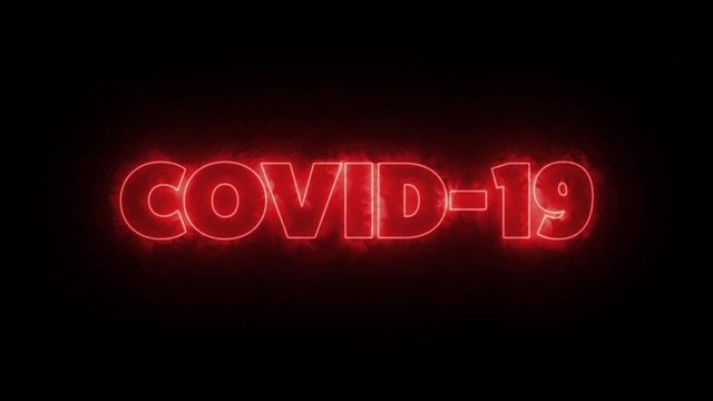COVID-19 text word written in glowish red letters on a black background. Animated Graphic motion design illustration advertising 4K UHD. Health, security, Pandemic, world lockdown.