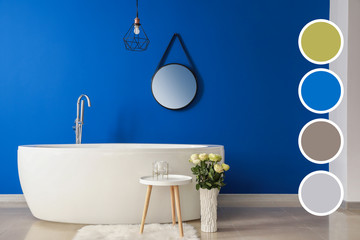 Interior of modern bathroom with blue wall. Different color patterns