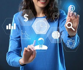 Woman using virtual screen on dark background. Time management concept