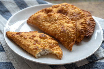 fried meat patties on a white plate, meat turnovers, asian cheburek