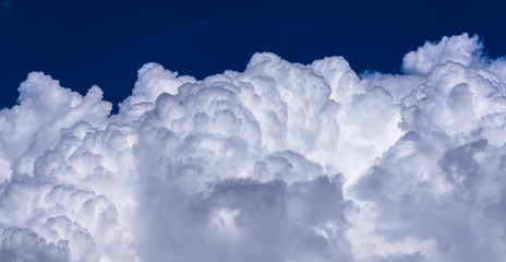 Bright light on cloudscape in deep blue sky