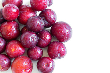Ripe juicy plums on white background
