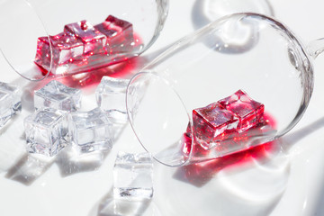 glass of red wine and pieces of ice.