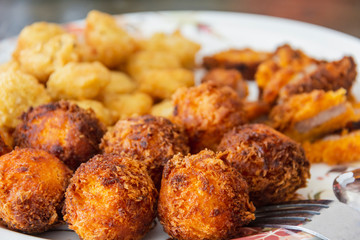 delicious cheese ball fried with chicken nugget on white disc ready eat