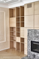 Wooden bookcases and wall panels around the fireplace