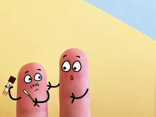 Two fingers are decorated as two person. One of them is trying to take his own nasal swab sample.