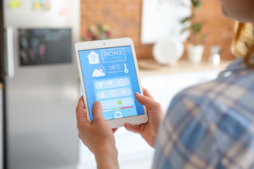 Woman using application of smart home automation