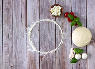 Template for recipe with italian pizza dough and fresh ingredients. Top view, copy space