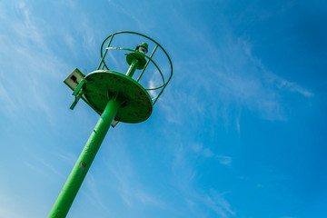Green lighthouse under blue sky in the port of Crikvenica. Crikvenica is a popular holiday resort in Kvarner riviera in Croatia - Powered by Adobe