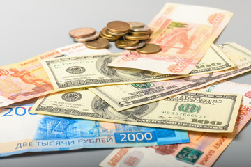 Cash banknotes and coins background. The background of the American and Russian money banknotes and coins. Dollars and rubles background.