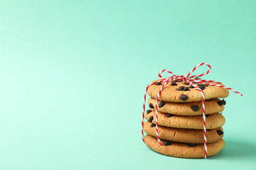 Pile of chocolate chip cookies on mint background
