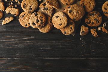 Tasty chocolate chip cookies on white wooden background