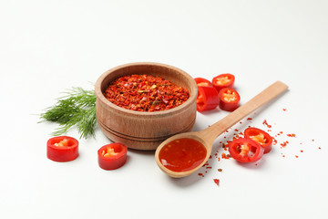 Composition with chilli pepper, spice and sauce on white background