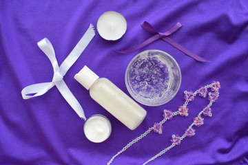 Fototapeta na wymiar Cosmetics for makeup and jewelry on a purple background. The view from the top.