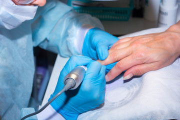 Manicure master at work removes the old nail coating