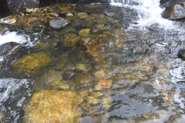 water floor over stones