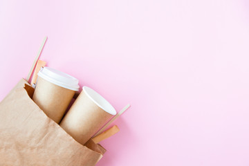 Eco-friendly disposable tableware for coffee take away on the pink background. concept of plastic free lifestyle.