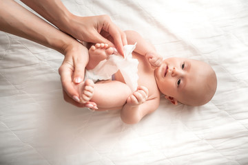Hygiene cleaning wipe, pure, clean. Mother cleaning up and wipes body and leg baby by wet tissue