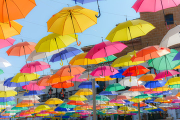 Fototapeta na wymiar Colourful umbrellas at small Spanish city of Torrox.