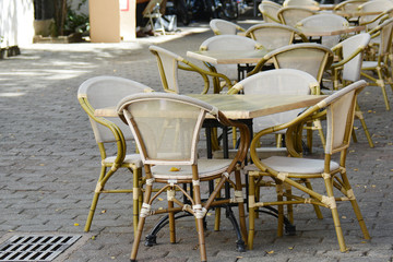 Fototapeta na wymiar row of wicker chairs and tables in the cafe