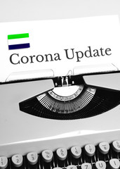 A Typewriter Typing the NEWS of COVID-19 with the Flag of Sierra Leone.