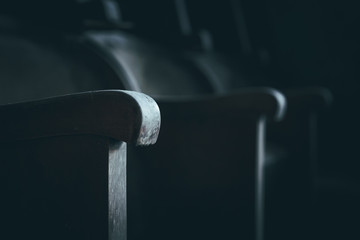 Stare, zniszczone fotele w ciemnym, opuszczonym kinie