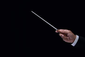 Orchestra conductor hands baton. Hands of conductor holding stick on a black background
