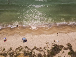 Fototapeta na wymiar Aerial view of sandy beach and sea with waves