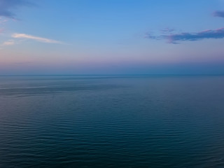 Fototapeta na wymiar Aerial panoramic view of sunrise over sea. Nothing but sky, clouds and water. Beautiful serene scene
