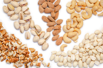 Assortment of nuts on white background. Group of mixed nuts. Top view