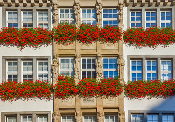 Traditional building with flowers on the balcony in Munich, Germany