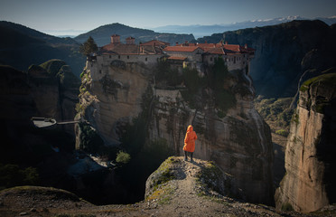 Tourist standing on Meteora rocks over Meteora monastery area
