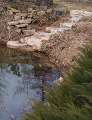 concrete steps down to the water are built of boulders