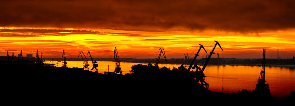 Sunset with the silhouette of an industrial crane and Danube river, Ruse city, Bulgaria