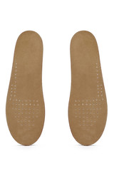 Subject shot of two beige insoles with suede surface and ventilation holes on the front parts. The orthotic insoles are isolated on the white backdrop. 