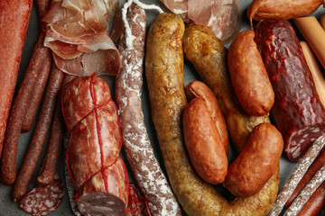 Different types of sausages on grey background, flat lay