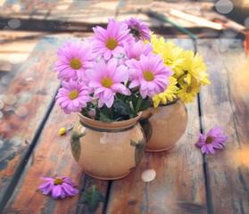 Spring flowers in a vase on the table. Multi-colored summer bouquets of chrysanthemums. The concept of summer bouquets. Allergy to flowers. Home garden. Decor and comfort in the house.