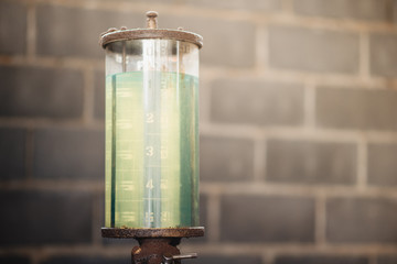An old, manually pumped petrol (gas) pump on a small, remote island in Thailand