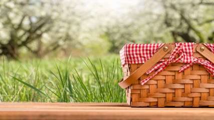 Picnic basket on a table against the background of nature. Rest and summer mood. Departure for a...