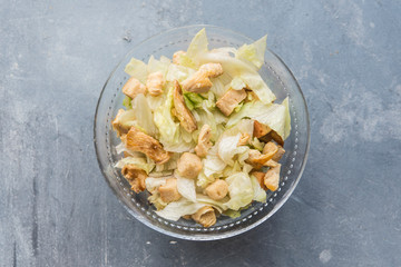 Caesar salad with toast, lettuce and grilled chicken breast