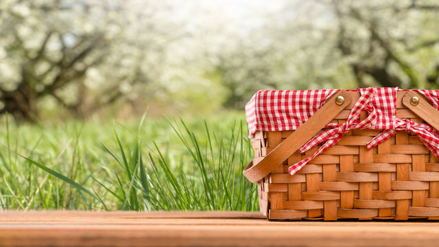 Picnic basket on a table against the background of nature. Rest and summer mood. Departure for a picnic on the weekend or vacation.