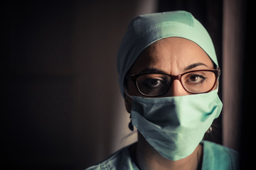 Woman doctor wearing a surgical mask and glasses