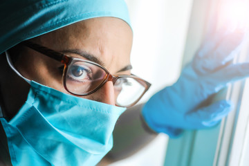 Woman doctor wearing a surgical mask and glasses