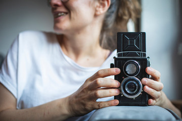 Fototapeta premium Photographer prepares her vintage analog medium format camera. 
