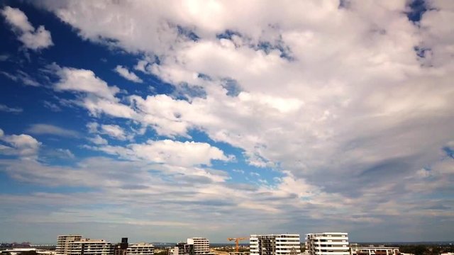 Cloud time lapse with blue sky in the background above buildings in Sydney. Australia.